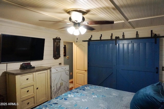 1034 S 3rd St, Coolidge, AZ 85128 - bedroom with a barn door, ceiling fan, and wood walls