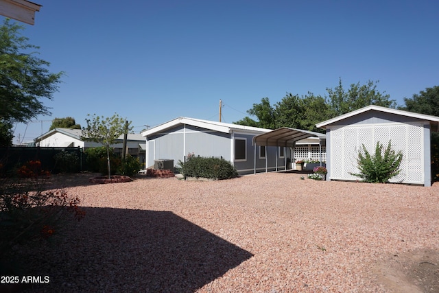 1034 S 3rd St, Coolidge, AZ 85128 - view of yard with gravel driveway and a carport