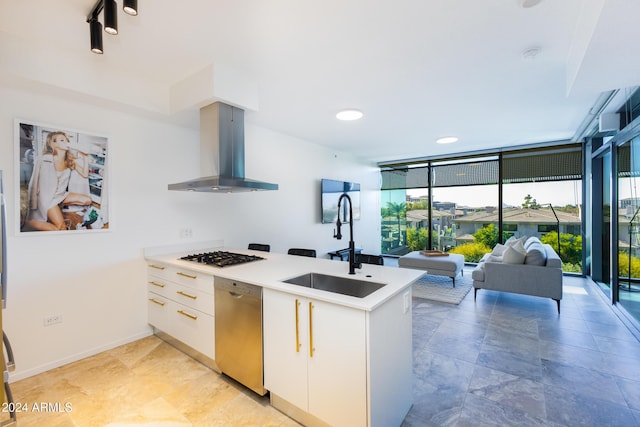 7120 E Kierland Blvd Unit 416, Scottsdale, AZ 85254 - kitchen with exhaust hood, stainless steel dishwasher, a wall of windows, a sink, and gas cooktop