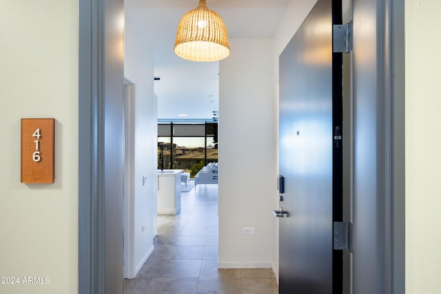 corridor with light tile patterned flooring