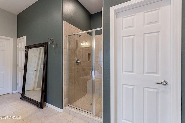 bathroom with tile patterned flooring and an enclosed shower