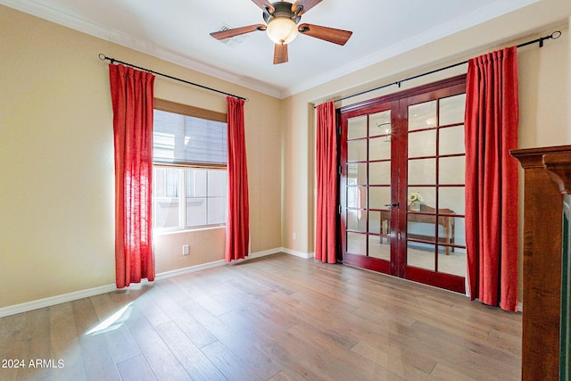 spare room featuring ceiling fan, french doors, light wood-type flooring, and crown molding