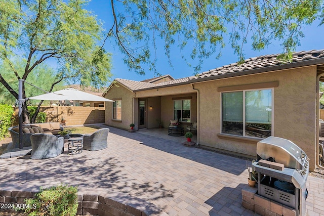 back of house with a patio and an outdoor living space