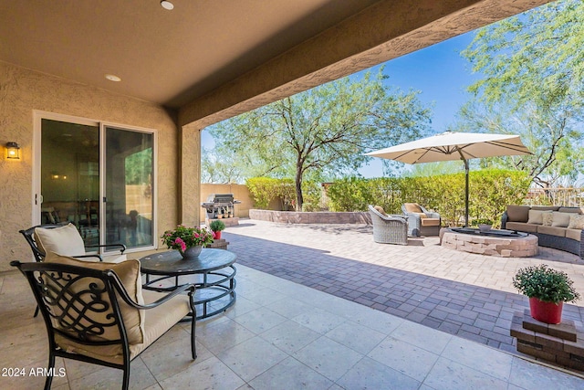 view of patio / terrace with an outdoor living space with a fire pit