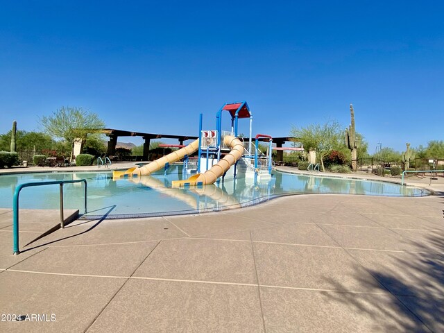 view of swimming pool featuring a water slide