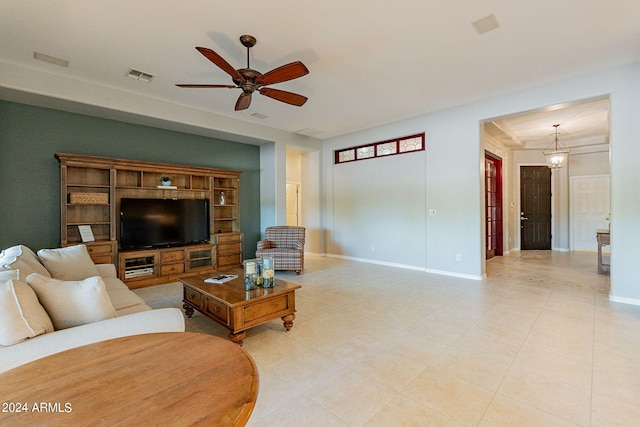 living room with ceiling fan with notable chandelier