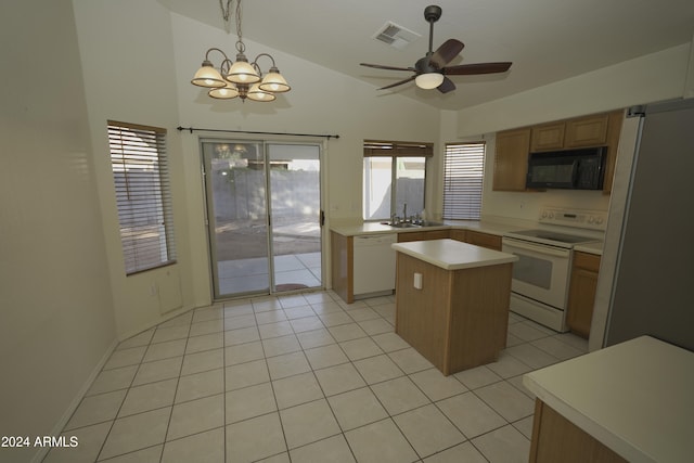 kitchen with sink, decorative light fixtures, white appliances, lofted ceiling, and a center island