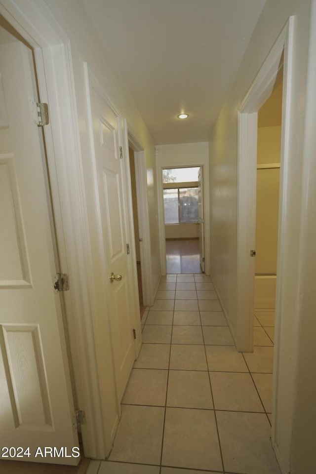 corridor with light tile patterned floors