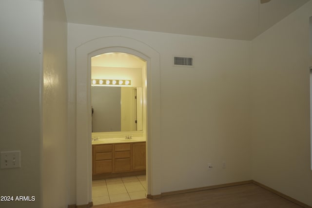 hallway featuring light hardwood / wood-style floors and sink