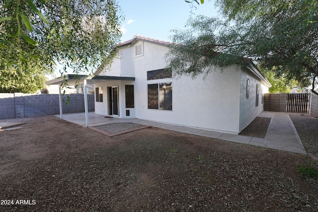 rear view of property featuring a patio area