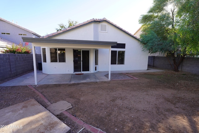 rear view of property featuring a patio