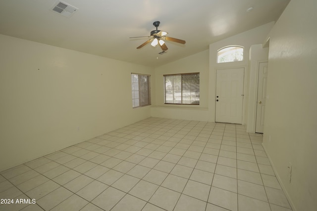 entryway with ceiling fan, light tile patterned floors, and lofted ceiling