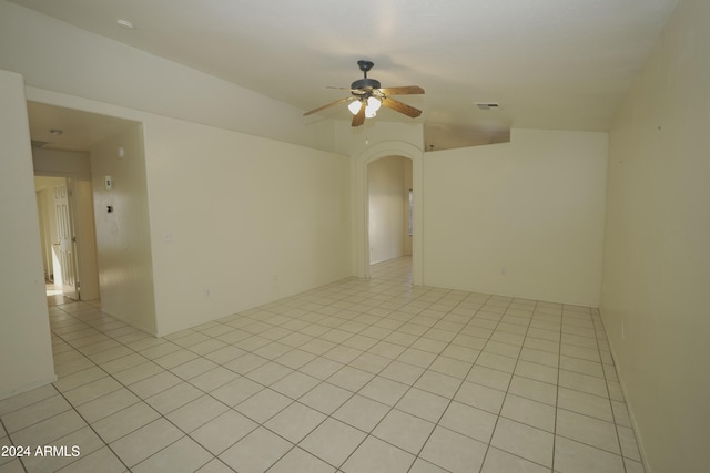 empty room featuring light tile patterned flooring and ceiling fan