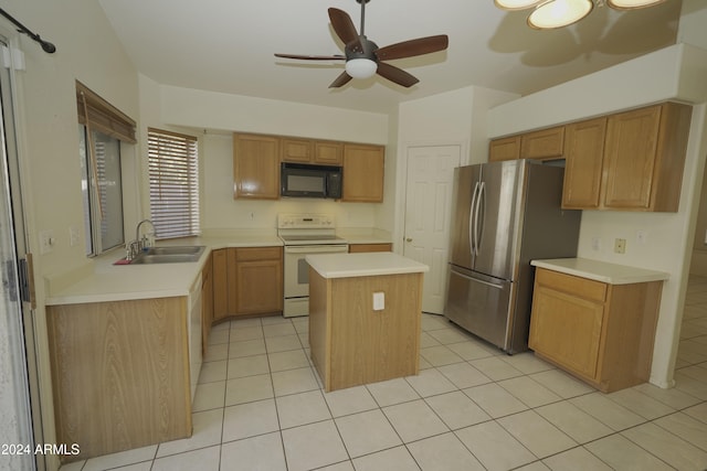 kitchen featuring a center island, sink, white appliances, and light tile patterned flooring