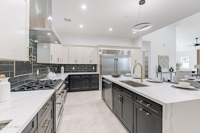 707 E Ocotillo Rd, Phoenix, AZ 85014 - kitchen featuring island exhaust hood, a sink, high end appliances, white cabinets, and dark cabinetry