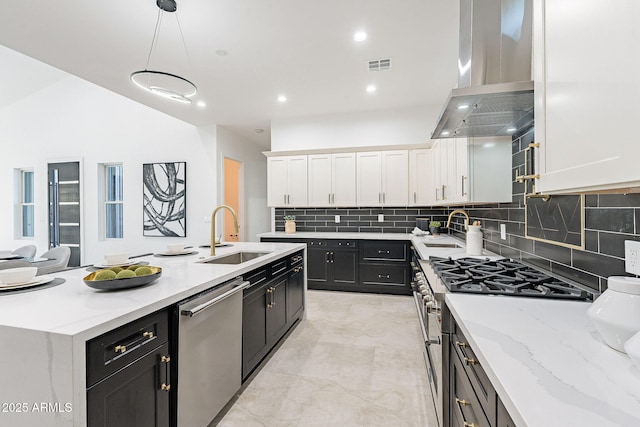 707 E Ocotillo Rd, Phoenix, AZ 85014 - kitchen featuring appliances with stainless steel finishes, exhaust hood, dark cabinetry, white cabinetry, and a sink