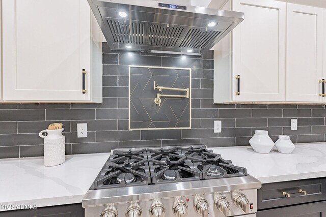 707 E Ocotillo Rd, Phoenix, AZ 85014 - kitchen with exhaust hood, cooktop, backsplash, white cabinets, and light stone counters