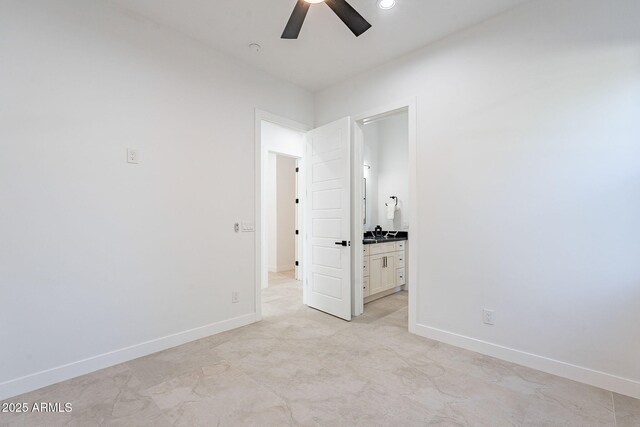 707 E Ocotillo Rd, Phoenix, AZ 85014 - unfurnished bedroom with baseboards, ensuite bathroom, and ceiling fan