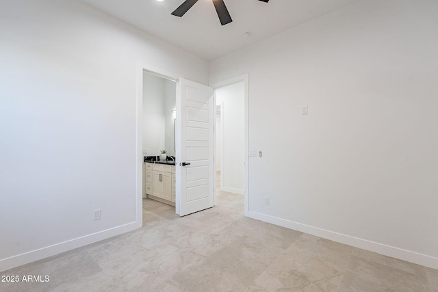 707 E Ocotillo Rd, Phoenix, AZ 85014 - unfurnished bedroom with baseboards, connected bathroom, a ceiling fan, and a sink