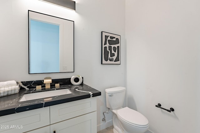 707 E Ocotillo Rd, Phoenix, AZ 85014 - bathroom with baseboards, toilet, and vanity