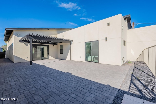707 E Ocotillo Rd, Phoenix, AZ 85014 - rear view of property featuring a pergola, stucco siding, and a patio