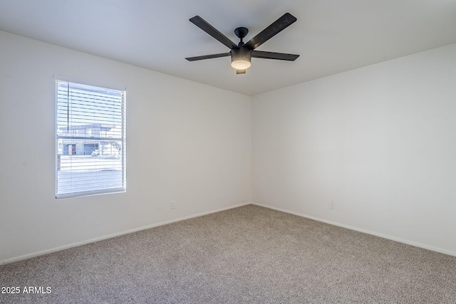 empty room featuring carpet floors and ceiling fan