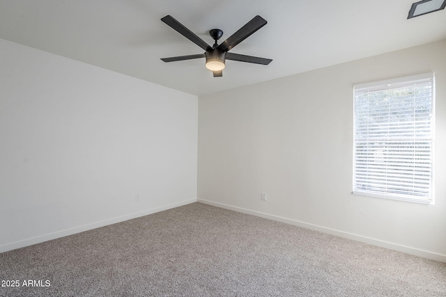 empty room with ceiling fan and carpet flooring