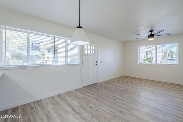 interior space featuring ceiling fan, a healthy amount of sunlight, and light wood-type flooring