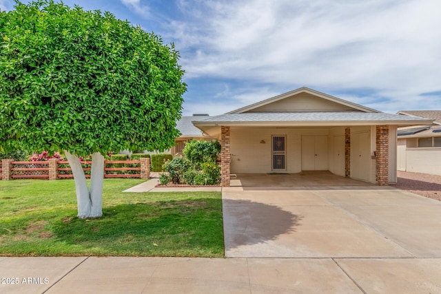 10724 W Cheryl Dr, Sun City, AZ 85351 - single story home featuring roof with shingles, driveway, a carport, and brick siding