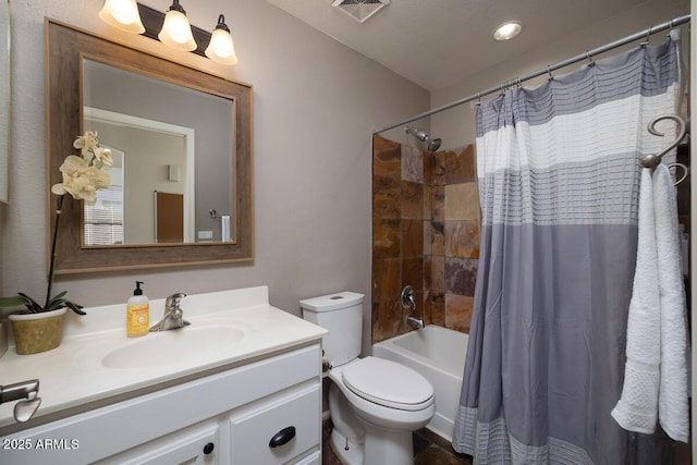 full bathroom with vanity, shower / bath combo, and toilet