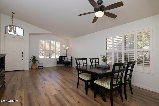 dining room featuring ceiling fan, lofted ceiling, and wood-type flooring