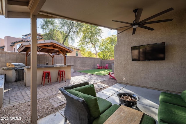 view of patio featuring a bar, a grill, a gazebo, and ceiling fan