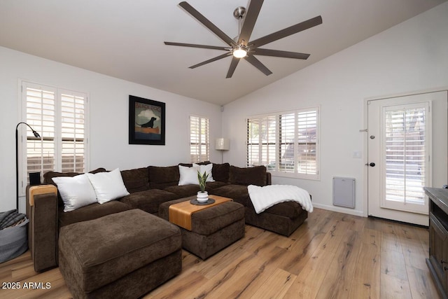 living room with vaulted ceiling, ceiling fan, and light wood-type flooring