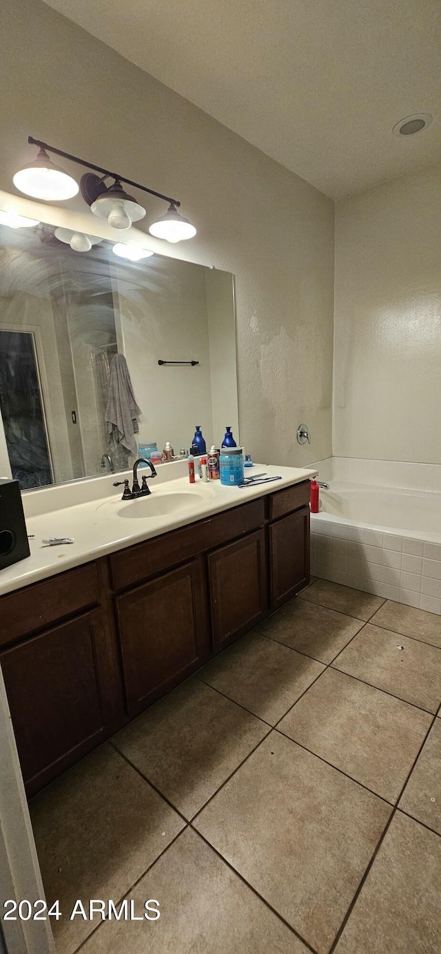 25422 W Maldonado Ct, Buckeye, AZ 85326 - bathroom with tile patterned flooring, tiled tub, and vanity