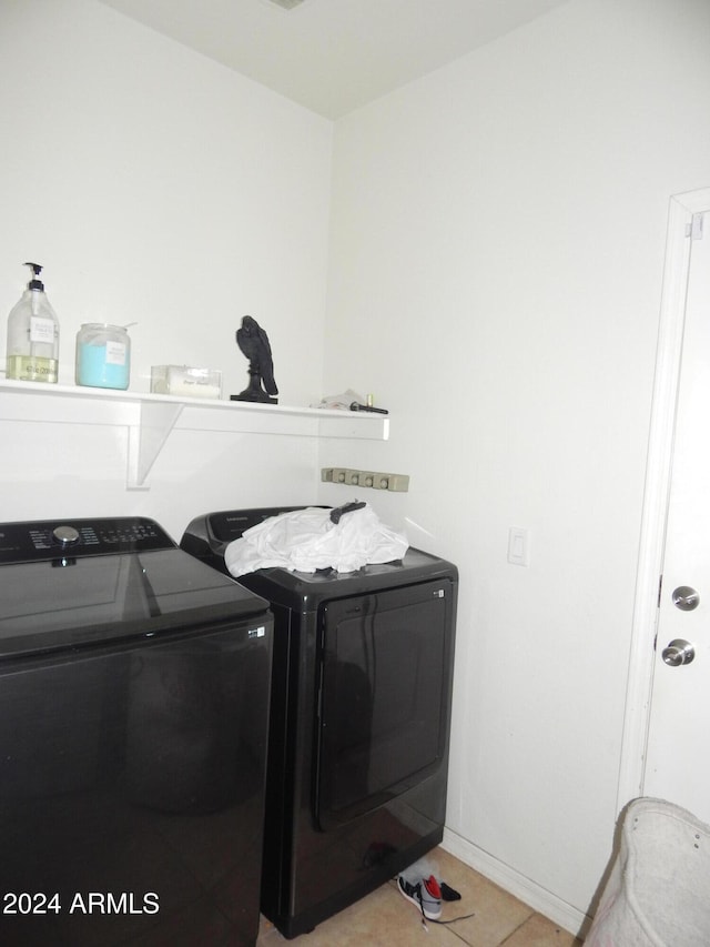 washroom with washer and dryer and light tile patterned flooring