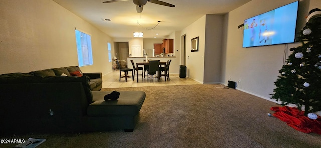 carpeted living room with ceiling fan