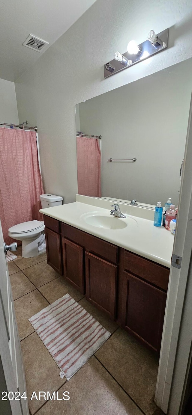 bathroom featuring tile patterned floors, vanity, and toilet