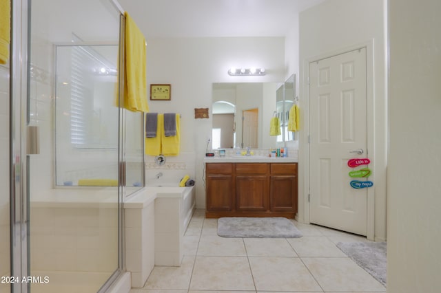 bathroom with tile patterned floors, vanity, and shower with separate bathtub