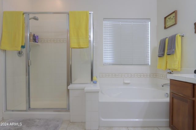 bathroom featuring tile patterned floors, vanity, and plus walk in shower