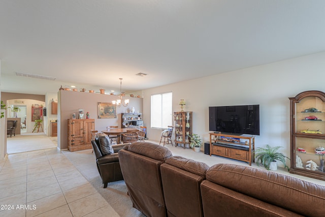 living room featuring light tile patterned floors and a chandelier