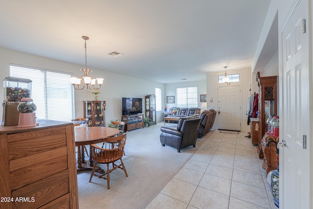 interior space featuring light tile patterned floors and a notable chandelier