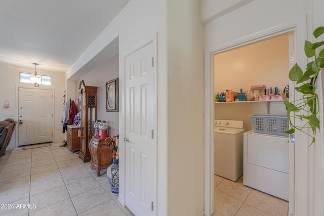 washroom featuring separate washer and dryer and light tile patterned floors