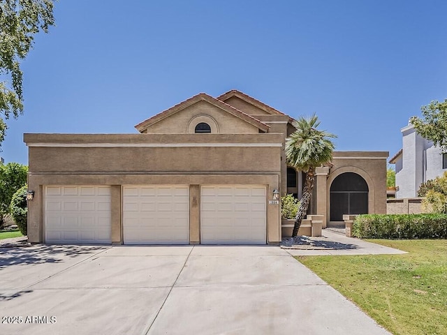 13064 N 100th Pl, Scottsdale, AZ 85260 - view of front of home with concrete driveway, a garage, stucco siding, and a front yard