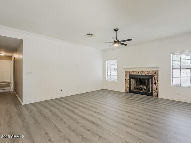 13064 N 100th Pl, Scottsdale, AZ 85260 - unfurnished living room featuring a ceiling fan, healthy amount of natural light, ornamental molding, wood finished floors, and baseboards