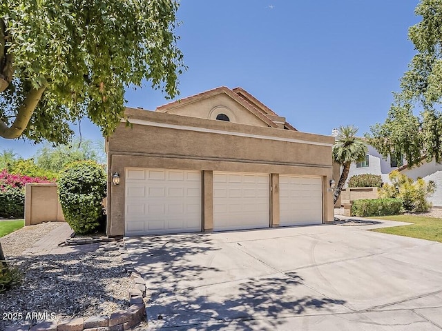 13064 N 100th Pl, Scottsdale, AZ 85260 - view of front facade featuring concrete driveway, stucco siding, and a garage