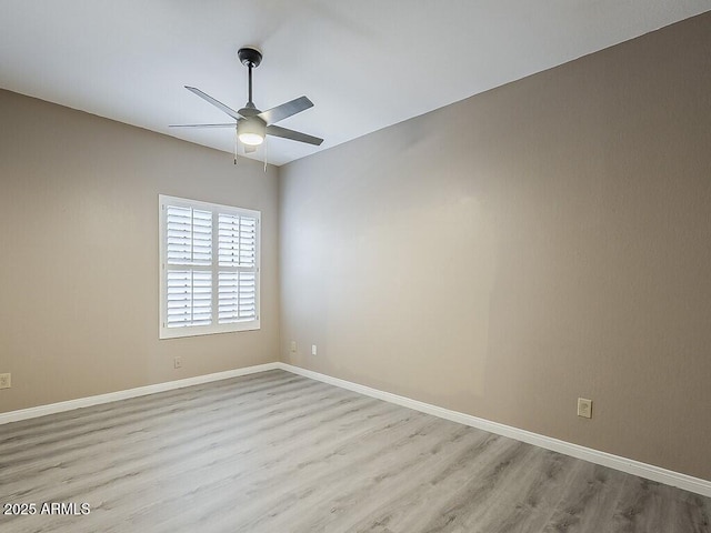 13064 N 100th Pl, Scottsdale, AZ 85260 - unfurnished room with ceiling fan, wood finished floors, and baseboards