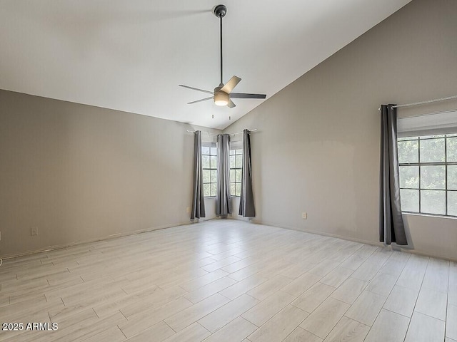 13064 N 100th Pl, Scottsdale, AZ 85260 - empty room featuring ceiling fan, plenty of natural light, light wood-style floors, and high vaulted ceiling