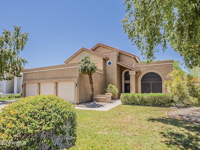 13064 N 100th Pl, Scottsdale, AZ 85260 - mediterranean / spanish home featuring an attached garage, a front lawn, and stucco siding