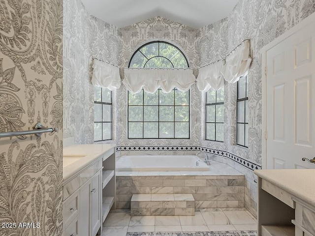 13064 N 100th Pl, Scottsdale, AZ 85260 - bathroom with wallpapered walls, a bath, vanity, and marble look tile flooring