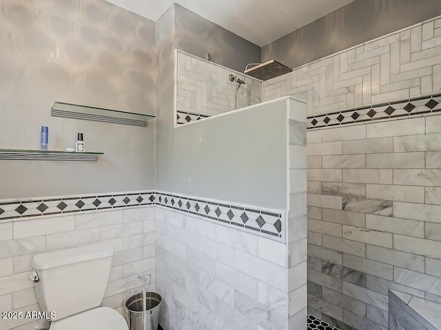 13064 N 100th Pl, Scottsdale, AZ 85260 - bathroom with toilet, walk in shower, tile walls, and wainscoting